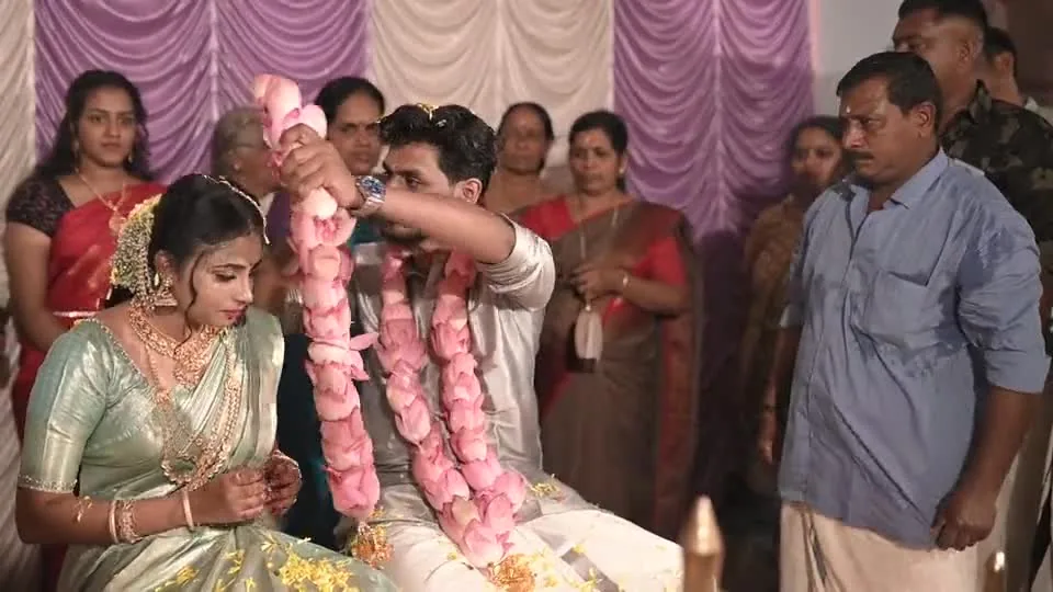 A couple exchanging flower garlands during a Hindu ceremony