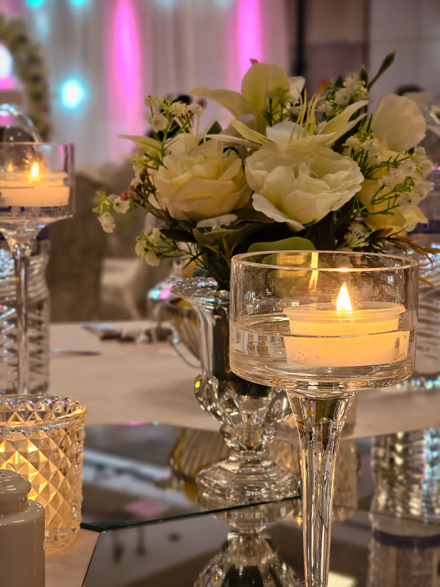 Candles and white roses on a table