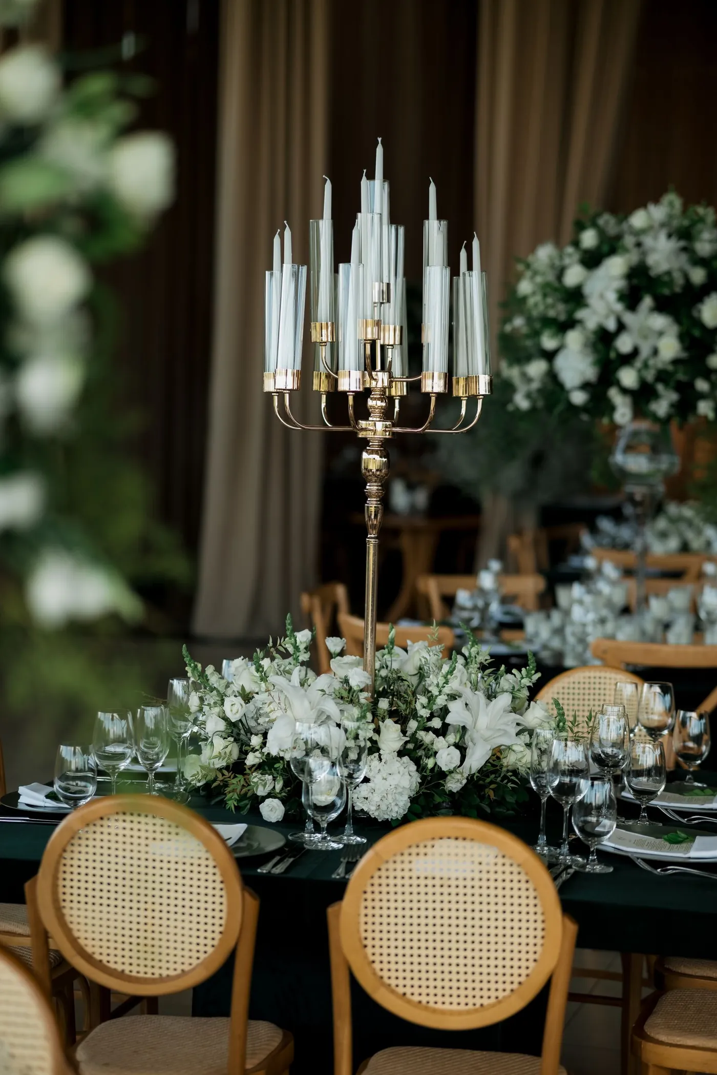 A garden reception table with greenery and candles